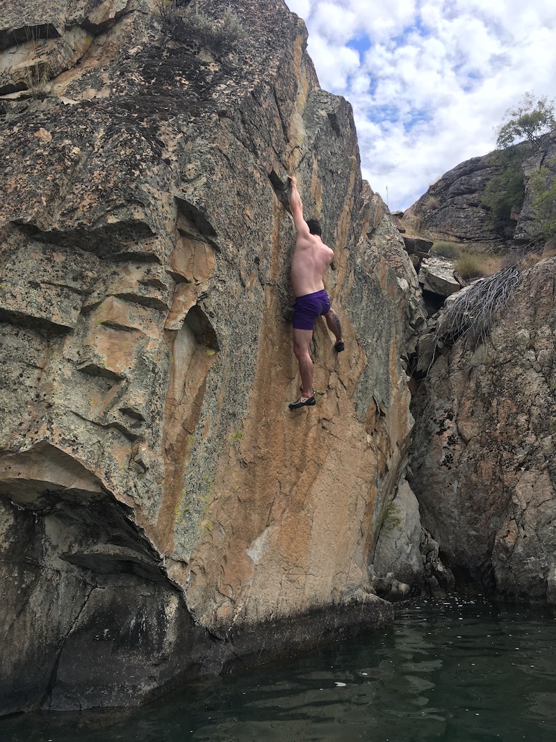 Jake climbing a cliff